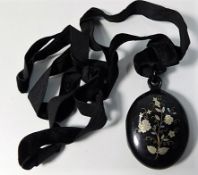 A Victorian tortoiseshell mourning locket with inl