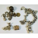 A silver charm bracelet, a silver Land Rover charm