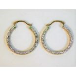 A pair of 9ct gold earrings with decorative white