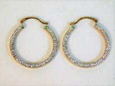 A pair of 9ct gold earrings with decorative white