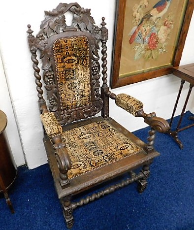 An upholstered late Victorian oak throne chair