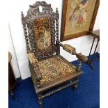 An upholstered late Victorian oak throne chair