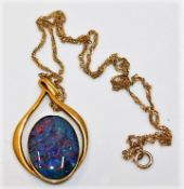 A 9ct gold chain 14" long & pendant with a black opal doublet