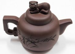 A Chinese Yixing clay teapot with lion decor finia