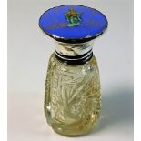 A silver topped scent bottle with enamel style déc