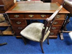 An antique pedestal desk with chair, fault to one