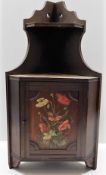 An antique mahogany corner wall cabinet with hand