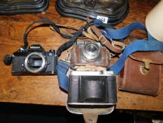 A Voigtlander camera, a Niko camera body & one oth