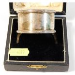 A cased silver napkin ring, initialled MDT, 38.4g