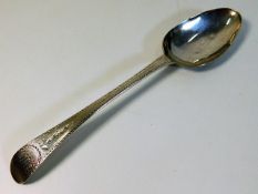 A Georgian bright cut patterned spoon by George Gr