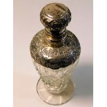 A decorative silver topped scent bottle 6in tall