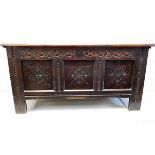 A good, early 17thC. oak coffer with carved decor