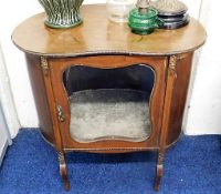 An early 20thC. kidney shaped drinks cabinet with gilt metal decor, some faults twinned with a cane