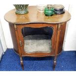 An early 20thC. kidney shaped drinks cabinet with gilt metal decor, some faults twinned with a cane