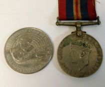 An WW2 medal twinned with a £5 crown