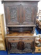 A c.1800 carved oak Dutch dresser with figurative