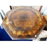 An octagonal table with decorative veneered finish