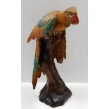 A large, decorative carved wood polychrome parrot