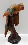 A large, decorative carved wood polychrome parrot