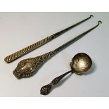 Two silver handled implements twinned with a decor