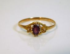 An antique ring set with possibly a pink sapphire