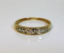 A yellow metal half eternity ring set with 0.25ct