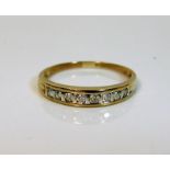 A yellow metal half eternity ring set with 0.25ct