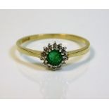 An 18ct gold ring set with emerald & small diamond