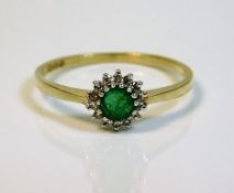 An 18ct gold ring set with emerald & small diamond
