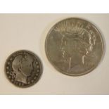 A 1923 silver dollar coin twinned with a 1905 quar