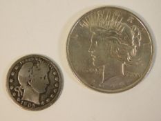 A 1923 silver dollar coin twinned with a 1905 quar