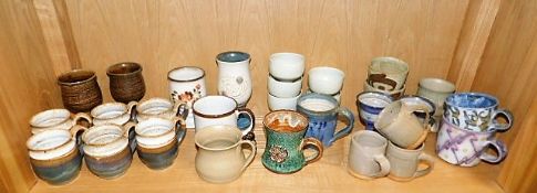 A quantity of studio pottery mugs