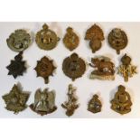 A quantity of military cap badges