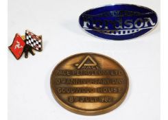 A Fordson tractor badge, a TT races brooch & a Goo