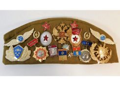 A Russian beret with a collection of badges. Prove