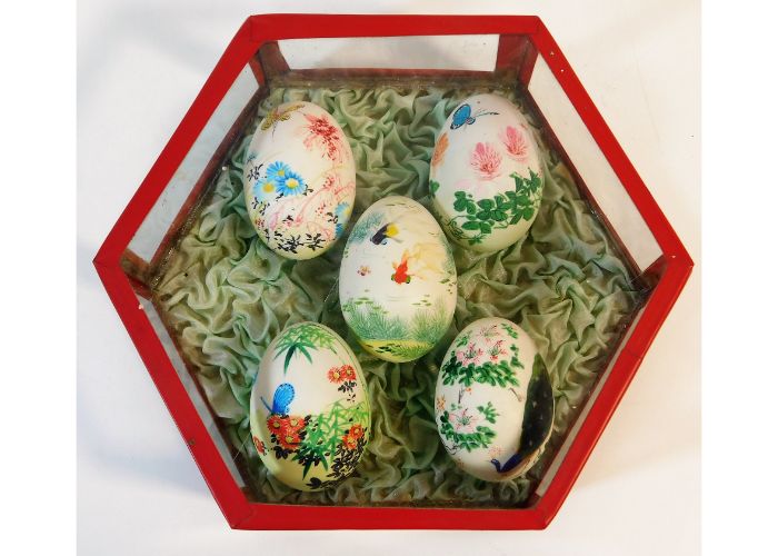 A set of five hand painted fowl eggs on ruffled si