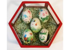A set of five hand painted fowl eggs on ruffled si