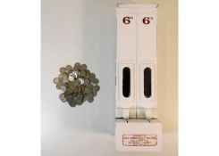 A wall mounted Aspro sixpence chocolate dispenser,