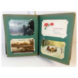 A vintage postcard album, mostly greetings cards a