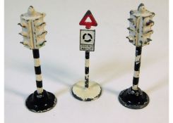 Three Dinky diecast toy road signs