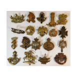 A quantity of military cap badges