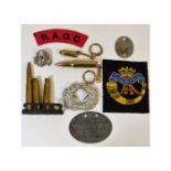 A German style skull pin, a Nazi German oak leaf wreath cap badge, a German tag "Ernst Matusch no.30