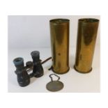 Two WW1 shells twinned with a pair of binoculars &