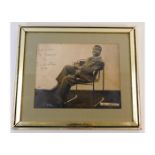 A framed photograph of Louis Armstrong, hand signe
