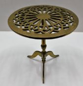 A heavy gauge brass trivet with pierced decor 12.6