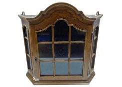 A glazed oak collectors display cabinet with shelv