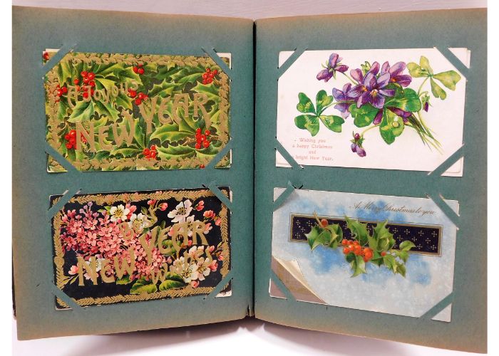 A vintage postcard album, mostly greetings cards a