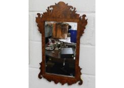 An antique mirror within decorative wooden frame 2