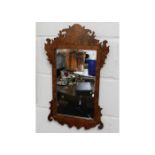 An antique mirror within decorative wooden frame 2