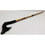 A two piece sectional bone cane with scrimshaw sty